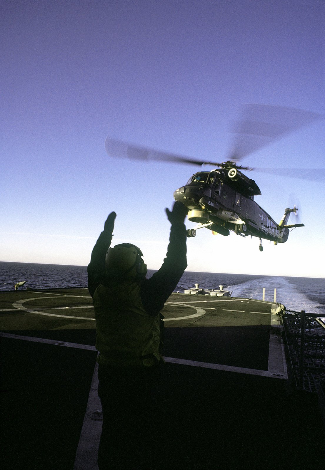 A Flight Deck Crewman Signals As Sh F Seasprite Light Airborne Multi