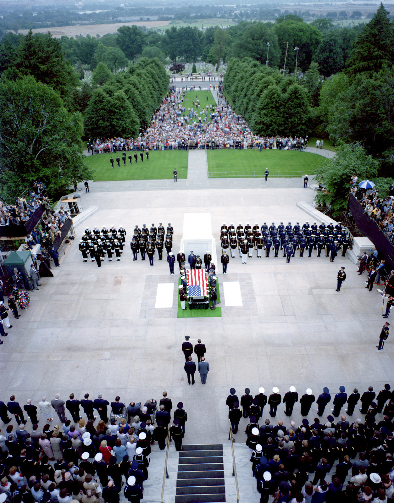 A Joint Services Casket Team Lifts The Flag Covering The Casket Of The