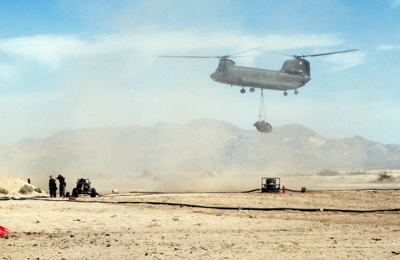 A Ch Chinook Helicopter Sling Lifts A Gallon Fuel Bladder For