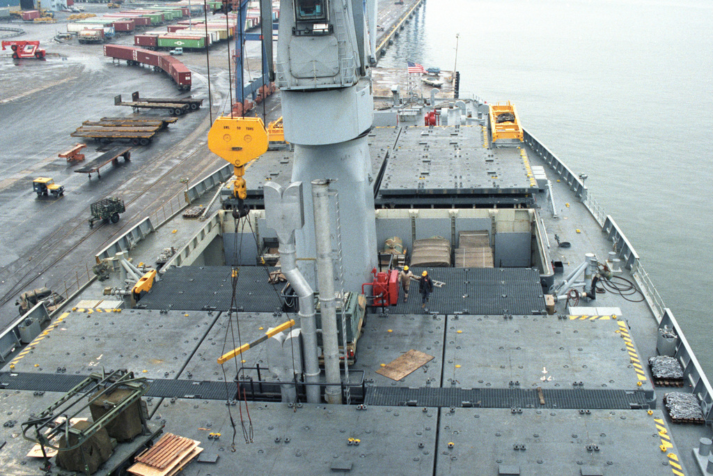 A Deck Mounted Crane Is Used To Remove Trucks From The Hold Of The