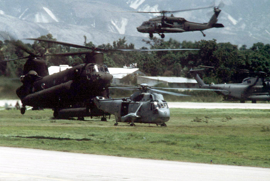 A Uh Black Hawk Blackhawk Helicopter Flys Over A Ch Chinook