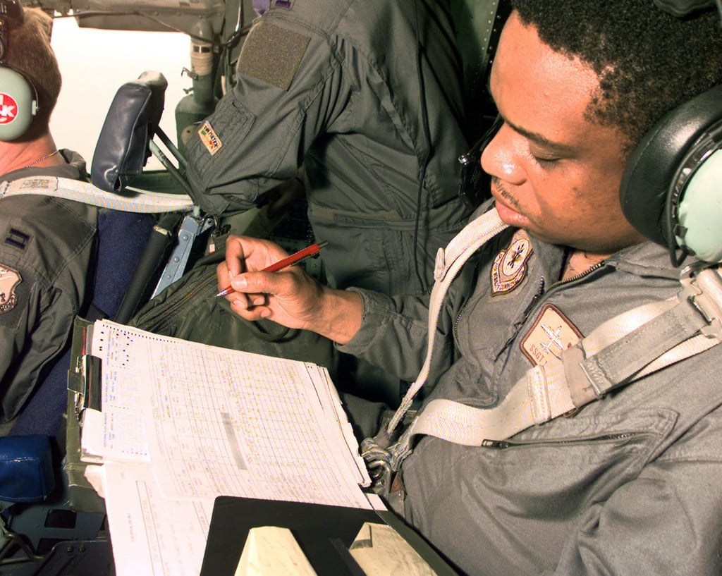 A Flight Engineer Fills Out Forms While In Flight Aboard His 43rd