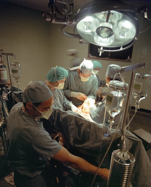 Major (Dr.) William R. Henrick, an anesthesiologist, monitors a patient ...