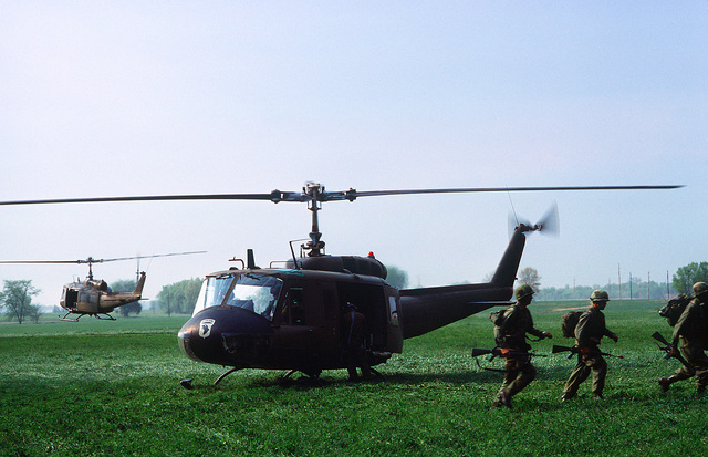 Members Of The 101st Airborne Division Deploy From A UH-1 Iroquois ...