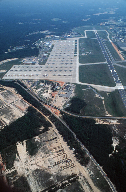 An aerial view of the base showing aircraft on standby and personnel ...