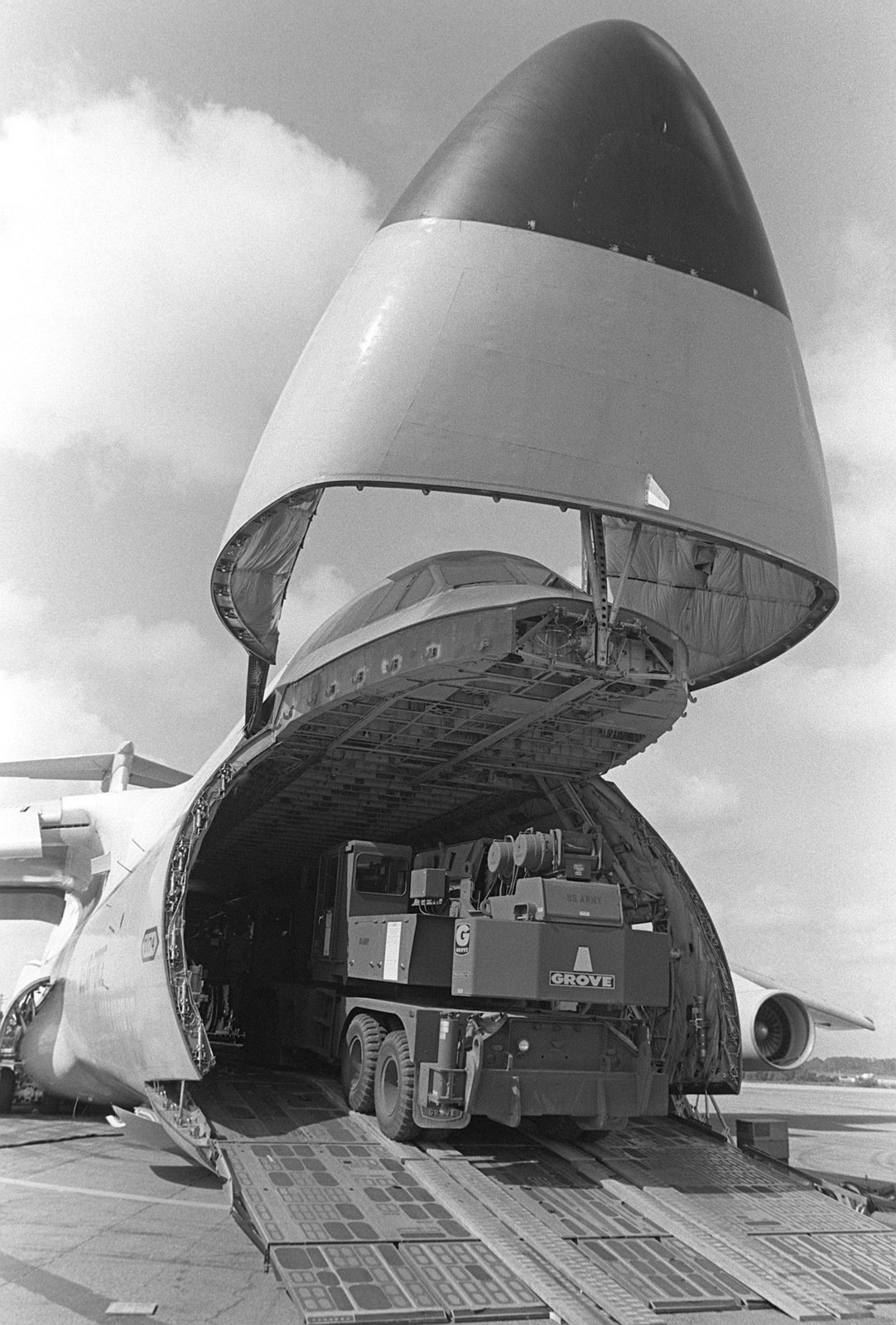 A 25-ton hydraulic crane is driven into the cargo hold of a C-5A Galaxy ...