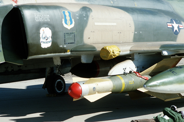 A GBU-15 glide bomb mounted on the wing pylon of an F-4 Phantom II ...