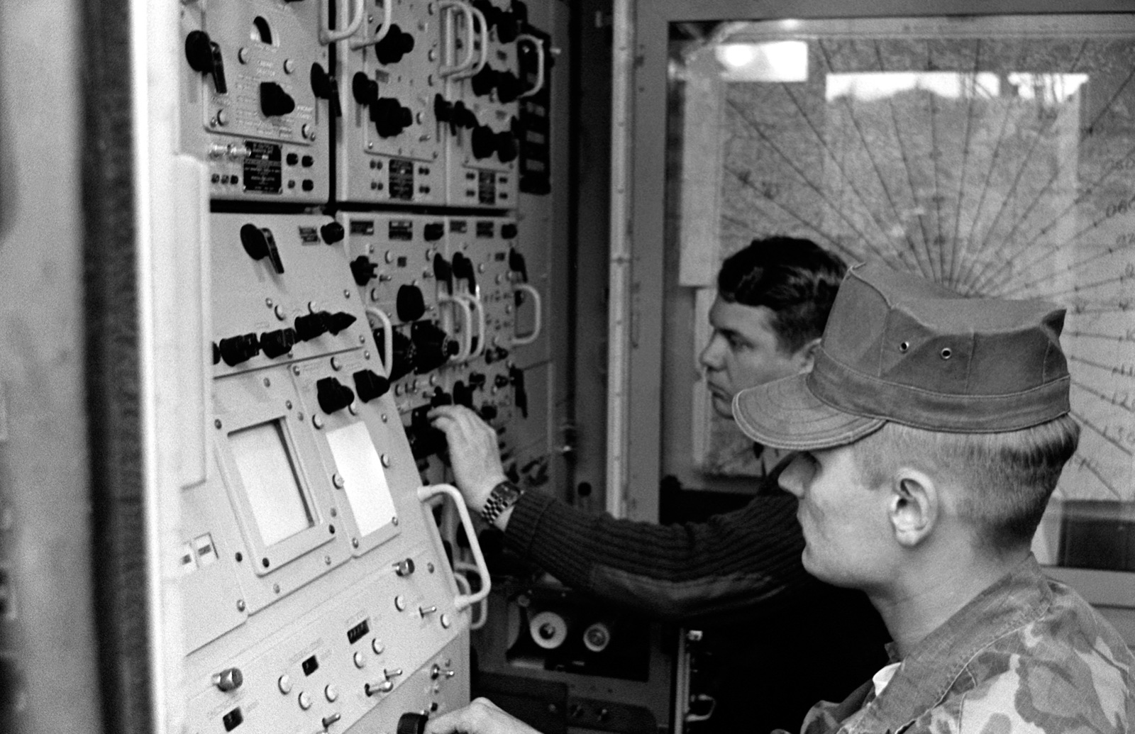 Two Marines operate the air support radar set. The radar is used to ...