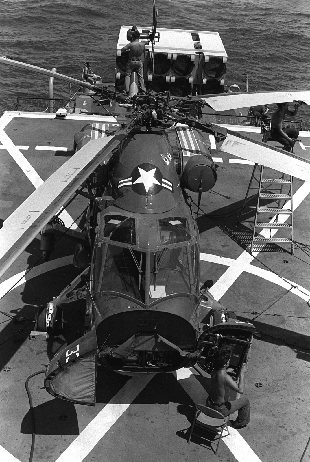 A crewman aboard the frigate USS TRIPPE (FF-1075) works on the nose ...