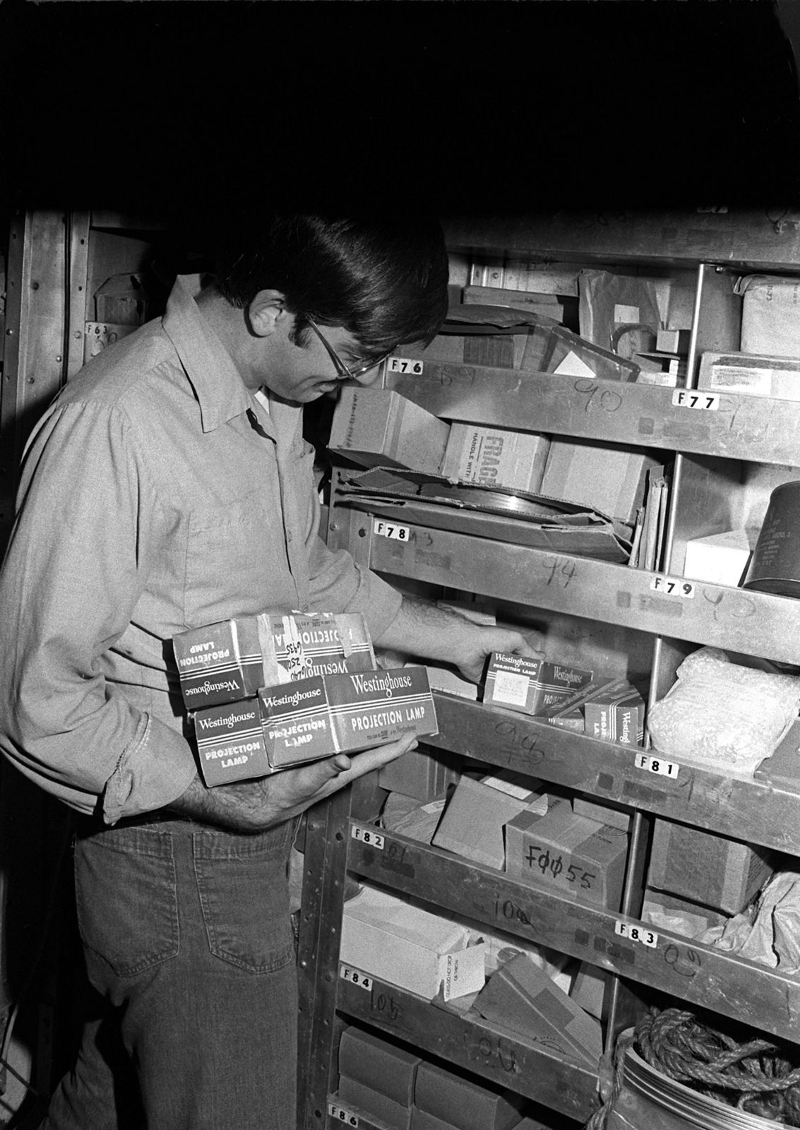 A storekeeper (SK) checks inventory items aboard his ship during