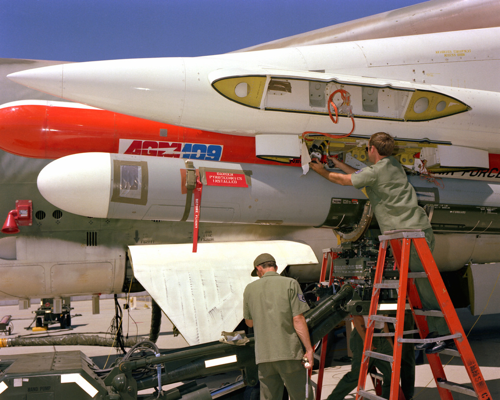 A Ground Crew Loads AGM-109 Tomahawk Air-launched Cruise Missiles On A ...