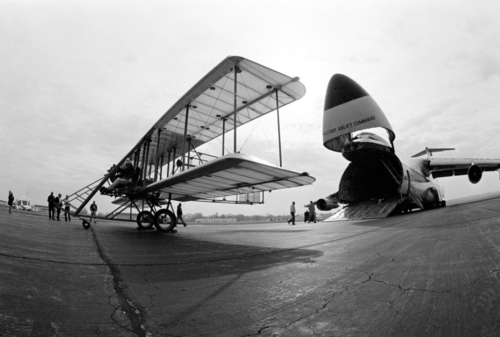 A Replica Of The 1911 Wright "B" Flyer On Display In Front Of A C-5A ...