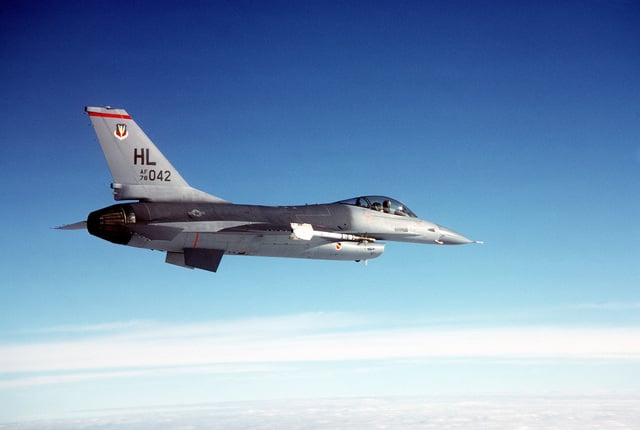 AN air-to-air right side view of an F-16 Fighting Falcon aircraft ...