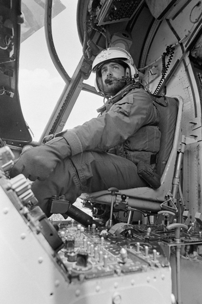 Lieutenant Junior Grade Michael G. Jegland, a pilot, in the cockpit of ...