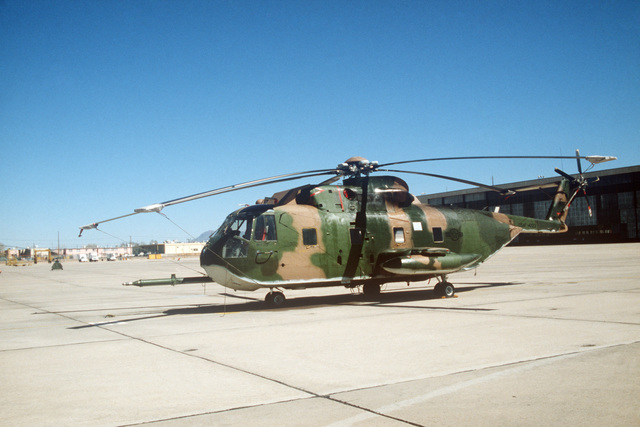 A right side view of an HH-3E Jolly Green Giant helicopter parked on ...