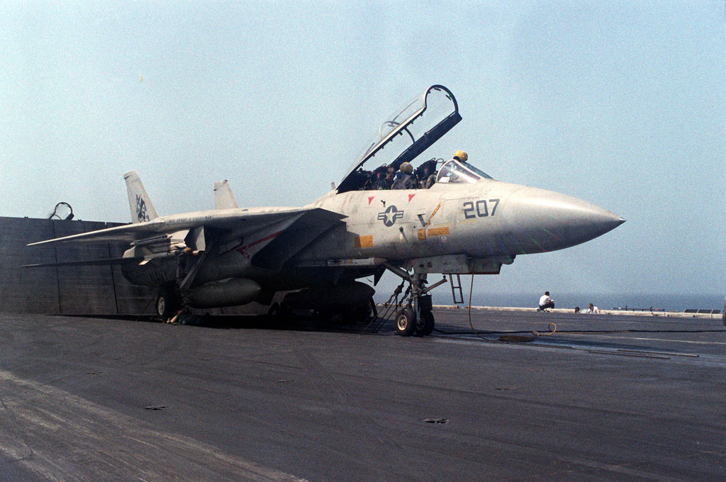 A right front view of an F-14 Tomcat aircraft, with the canopy open, as ...