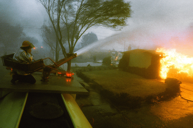 A firefighter operates a water hose during the Major Accident