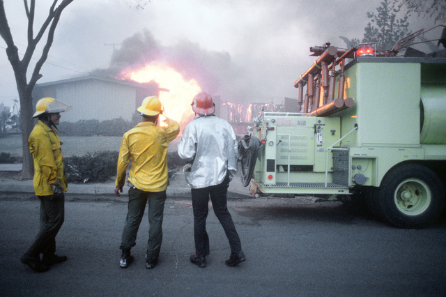 A firefighter operates a water hose during the Major Accident Response  Exercise (MARE) - NARA & DVIDS Public Domain Archive Public Domain Search