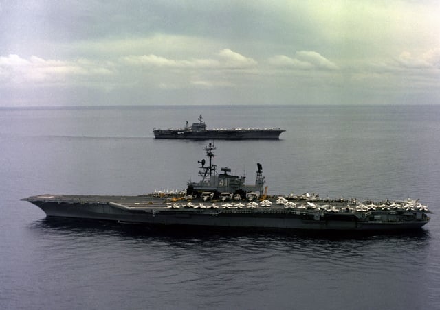 An aerial port beam view of the aircraft carrier USS MIDWAY (CV 41) and ...