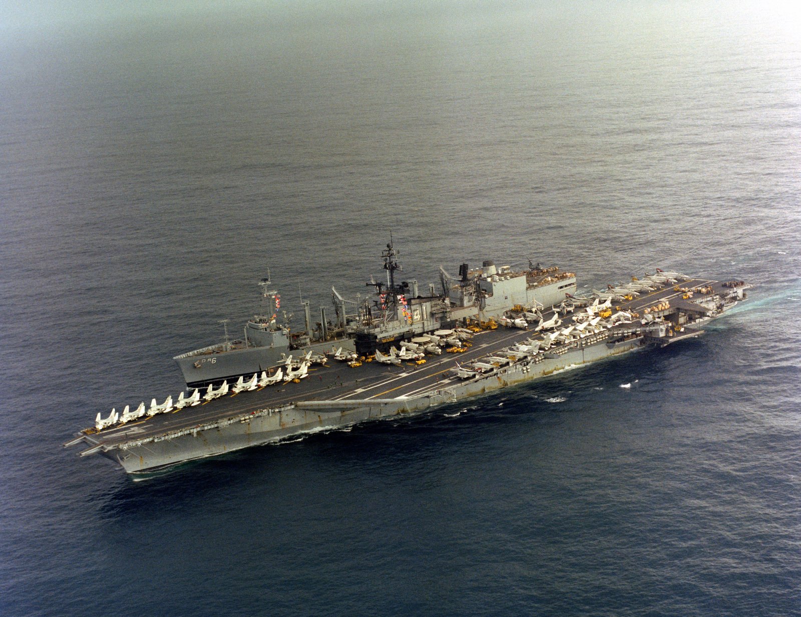 An aerial port bow view of the aircraft carrier USS MIDWAY (CV 41) and ...