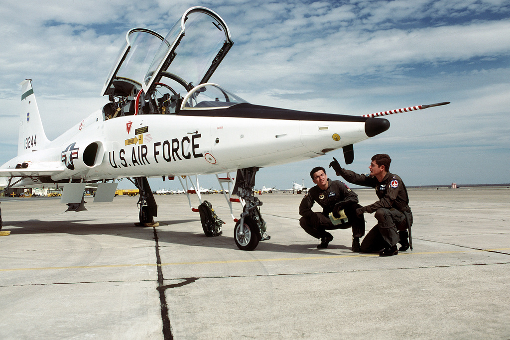 An instructor explains a T-38 Talon aircraft to a student in the