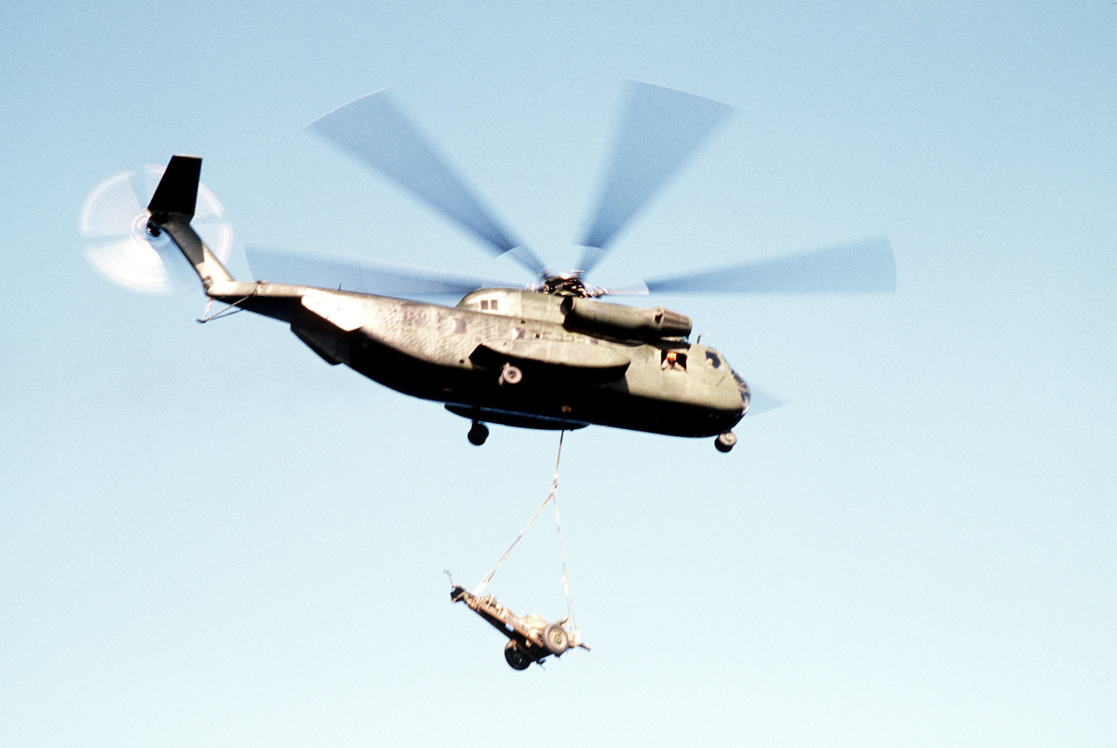 A Marine Corps CH-53D Sea Stallion Helicopter Airlifts A 105mm Howitzer ...