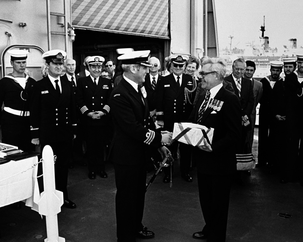 Sir Nicholas Parkinson makes a presentation to CMDR B. Wilson 