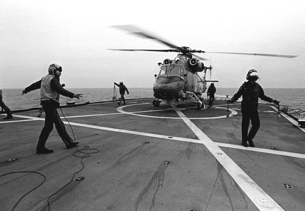 Flight deck crewmen aboard the destroyer USS JOHN HANCOCK (DD-981 ...