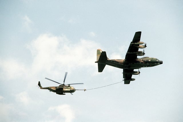 AN air-to-air right side view of an HC-130P Hercules aircraft refueling ...