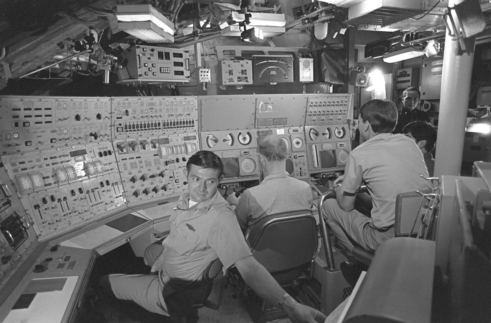 Three Crewmen In The Control Room Simulate Diving Operations