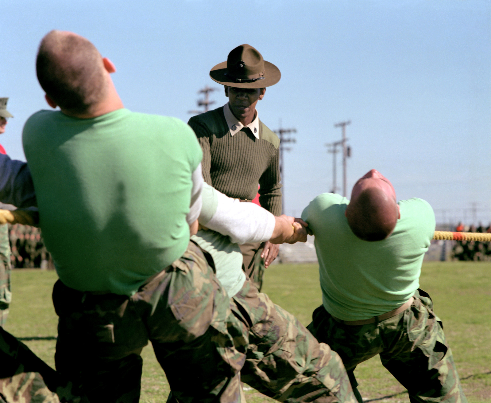 a-drill-instructor-encourages-a-group-of-recruits-to-give-their-all-in