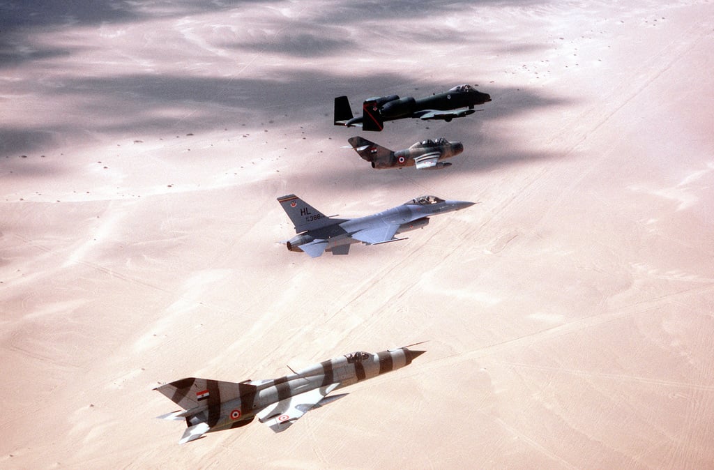 A right side view of aircraft in flight over the desert during exercise ...