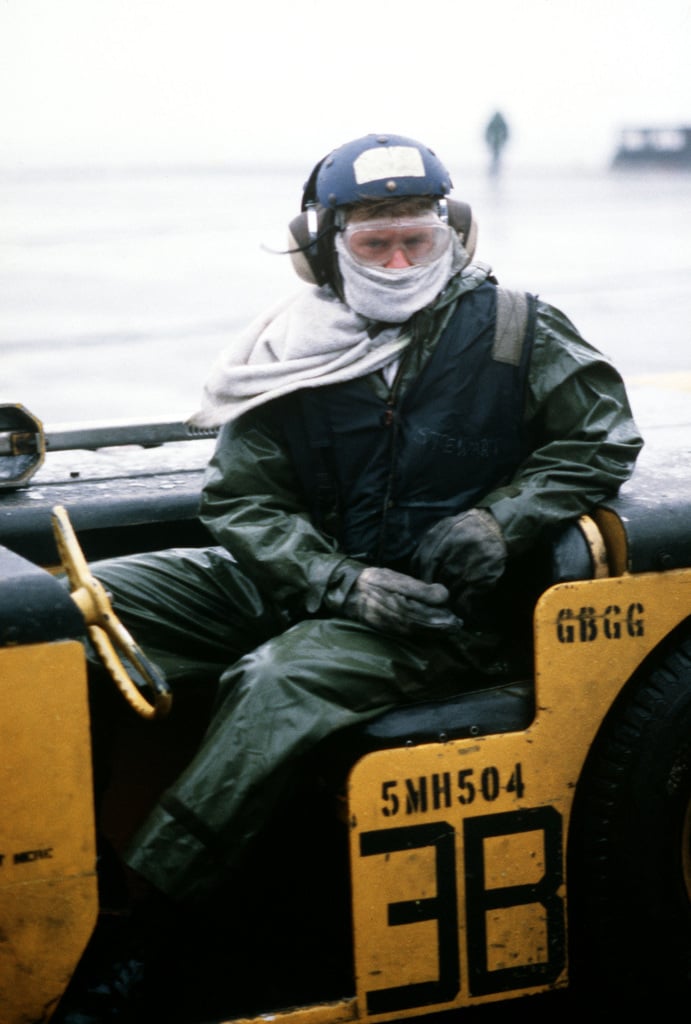 A Flight Deck Crewman Sits In A Vehicle Aboard The Aircraft Carrier USS AMERICA CV 66 NARA