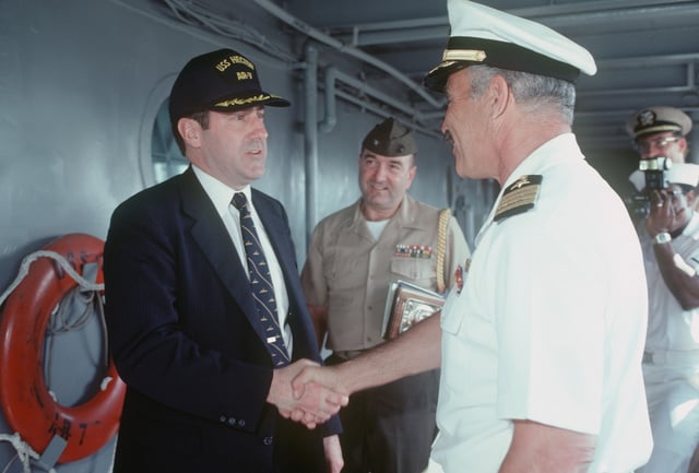 Assistant Secretary of the Navy John S. Herrington is greeted by ...