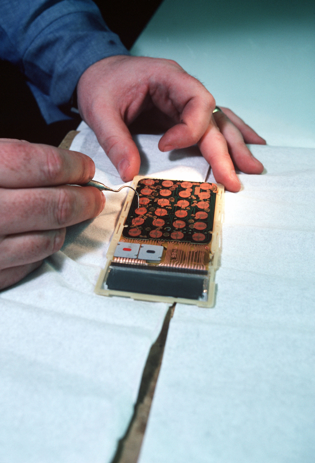 Electronics Technician 1ST Class (ET1) Robert Gates works on a piece of ...