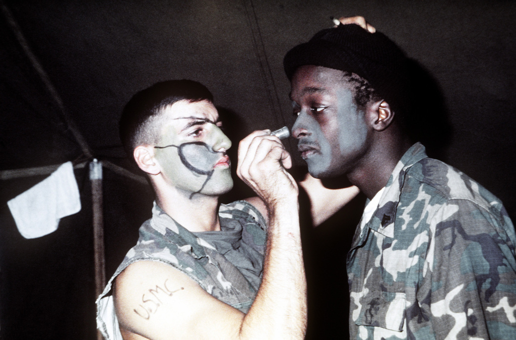 A Marine wearing camouflage face paint participates in Exercise