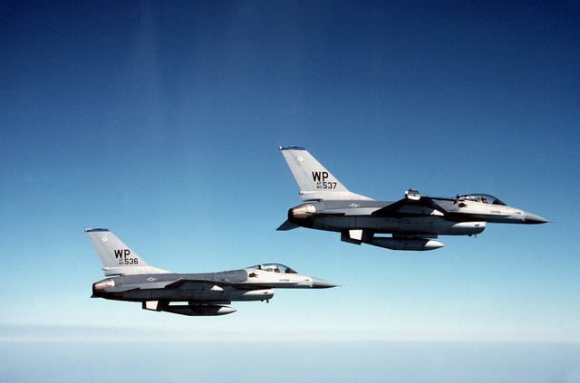 Right side view of two F-16 Fighting Falcon aircraft flying in ...