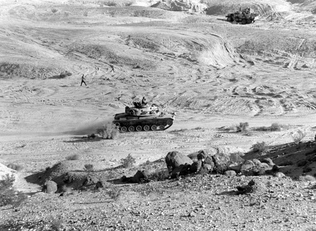 An M-60A1 tank from 2nd Marine Division moves forward against the ...