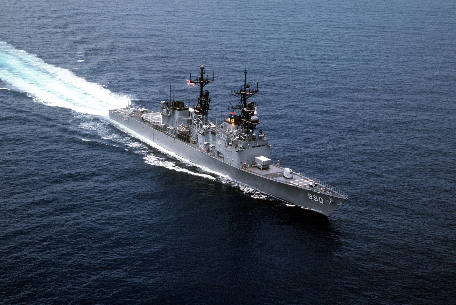 A high-angle starboard bow view of the Spruance class destroyer USS ...