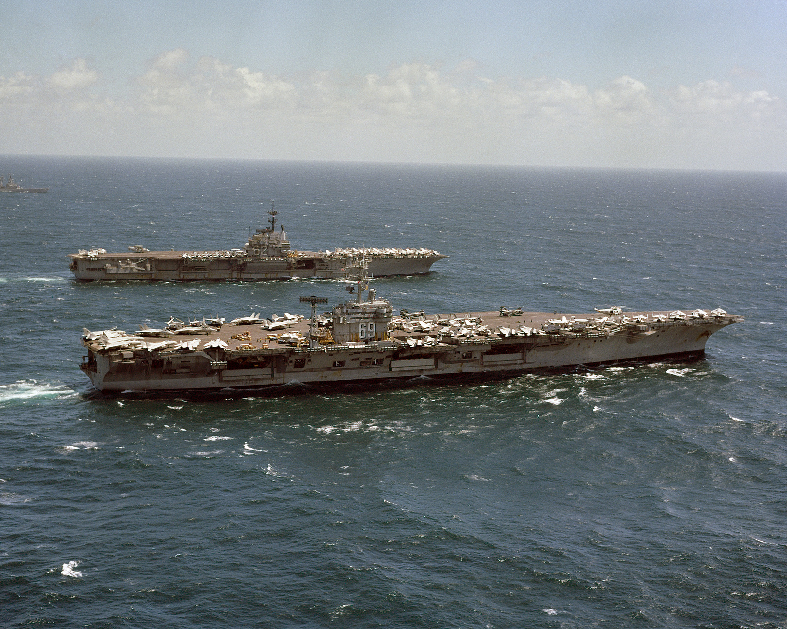 A starboard quarter view of the nuclear-powered aircraft carrier USS ...