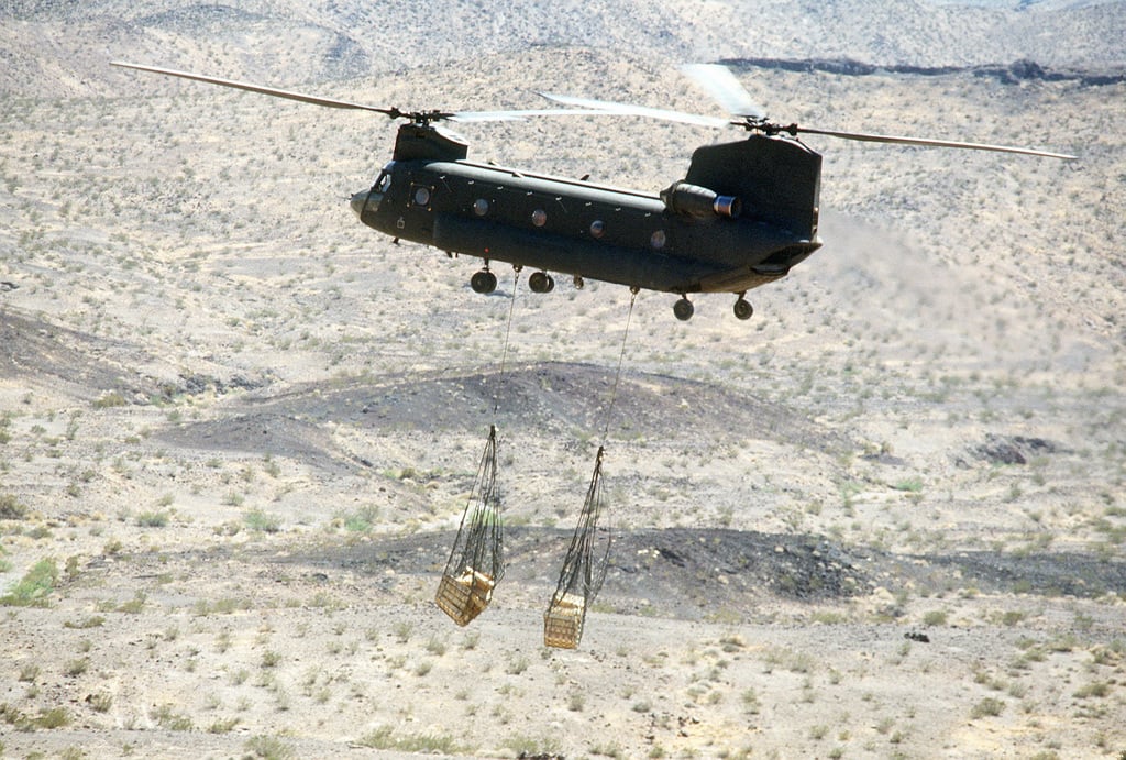 A 101st Airborne Division CH-47D Chinook helicopter airlifts supplies ...