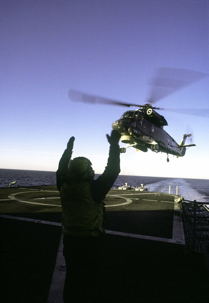 A Flight Deck Crewman Signals As SH-2F Seasprite Light Airborne Multi ...