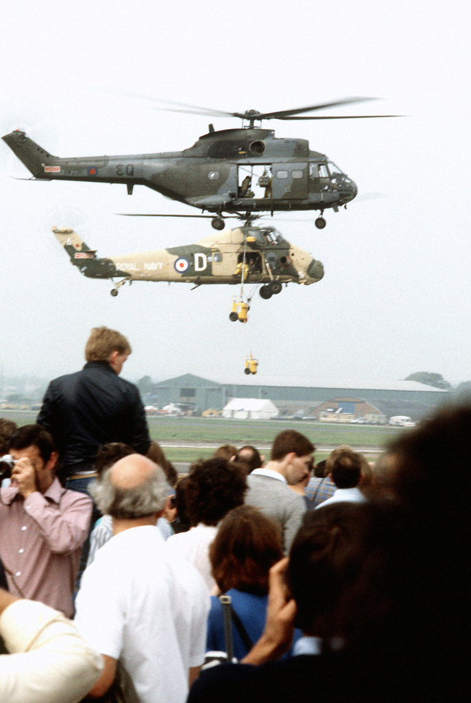 A right side view of two British Royal Navy helicopters on a ...