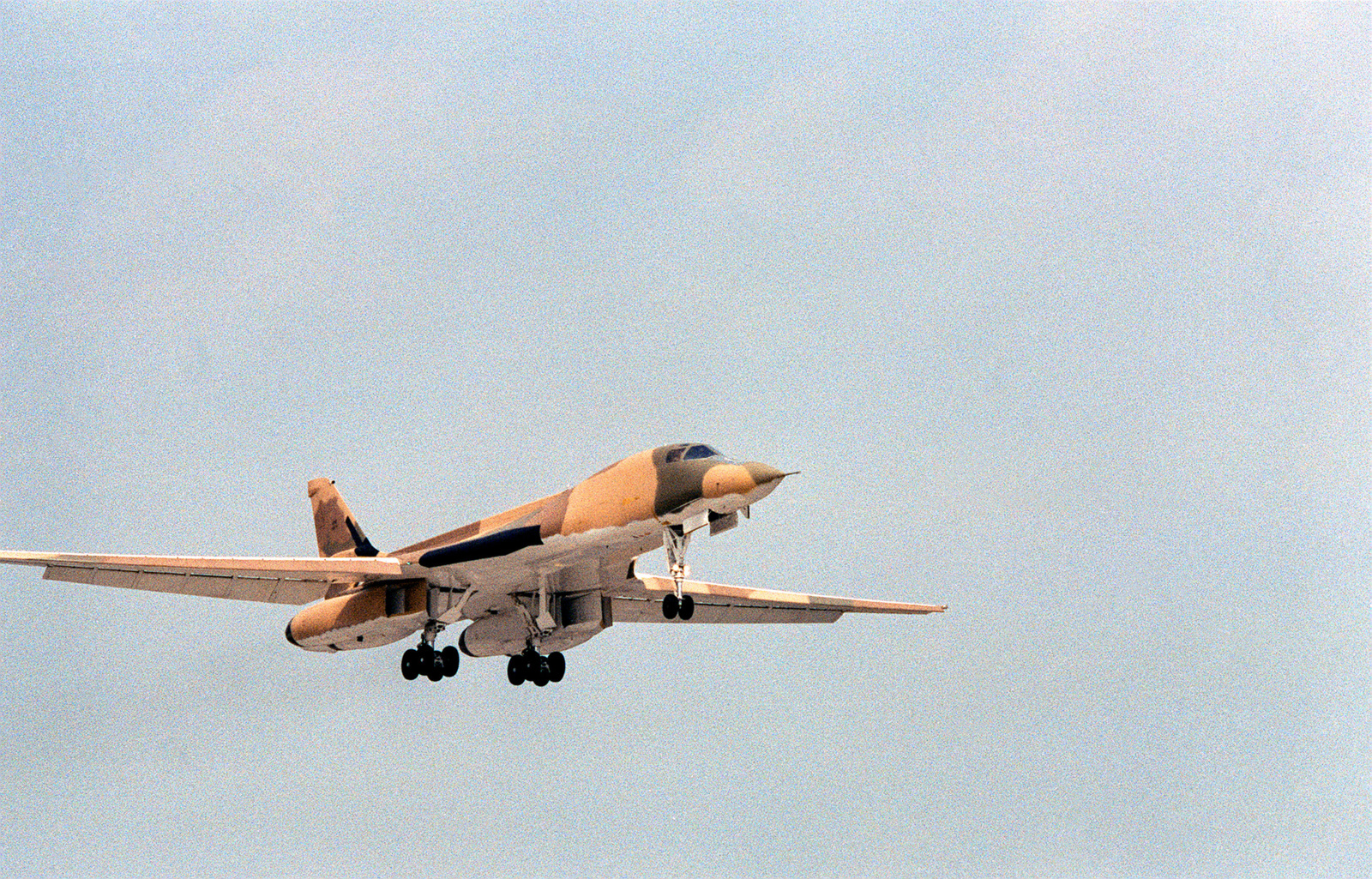 A Ground-to-air Right Front View Of A B-1 Bomber Flying Over The Runway ...