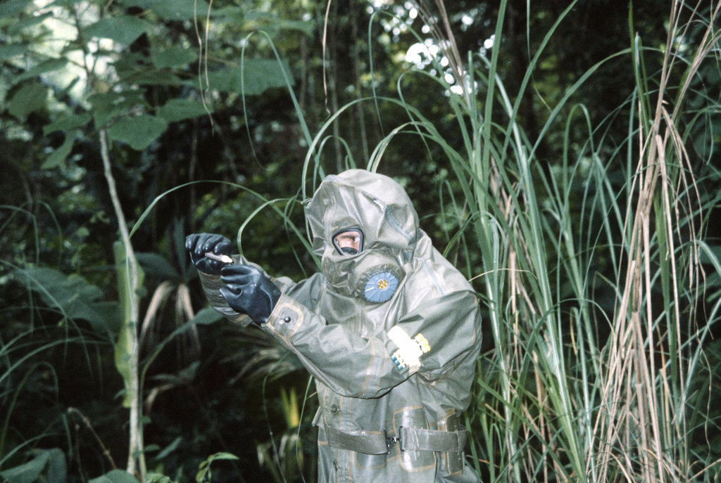 A member of the 36th Ordnance Department Team, wearing chemical protective  clothing, analyzes a liquid sample for possible contamination - PICRYL -  Public Domain Media Search Engine Public Domain Search