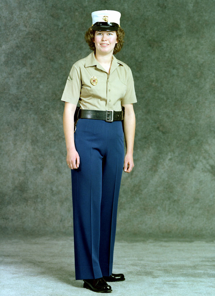 A woman Marine, military police, Lance CPL., is dressed in green slacks ...
