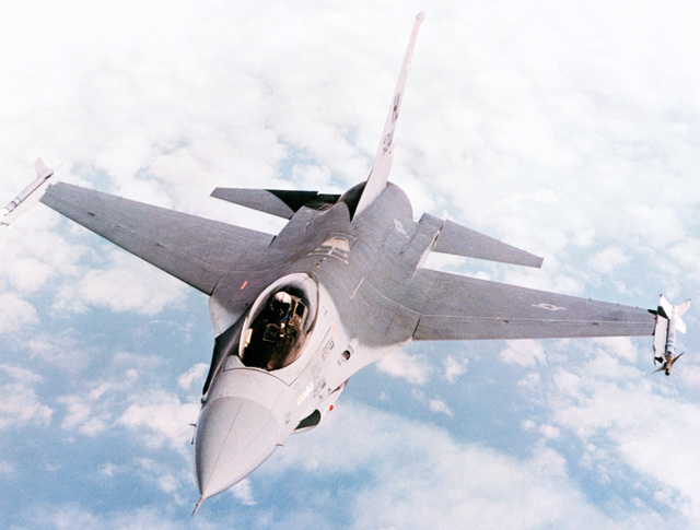 A high angle air-to-air front view of an F-16A Fighting Falcon aircraft ...