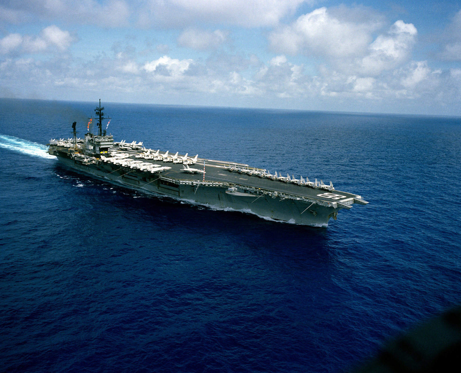 An aerial starboard bow view of the Kitty Hawk class aircraft carrier ...