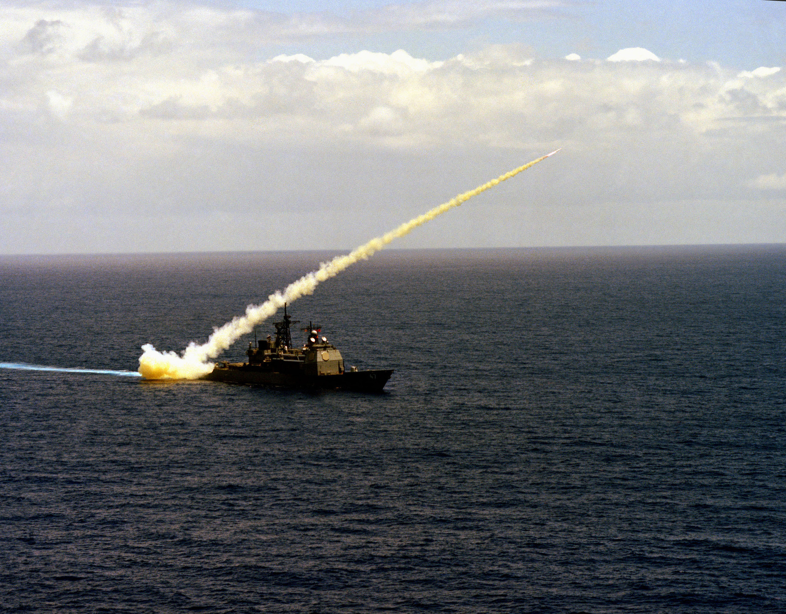 A Harpoon missile is launched from the Aegis guided missile cruiser USS ...