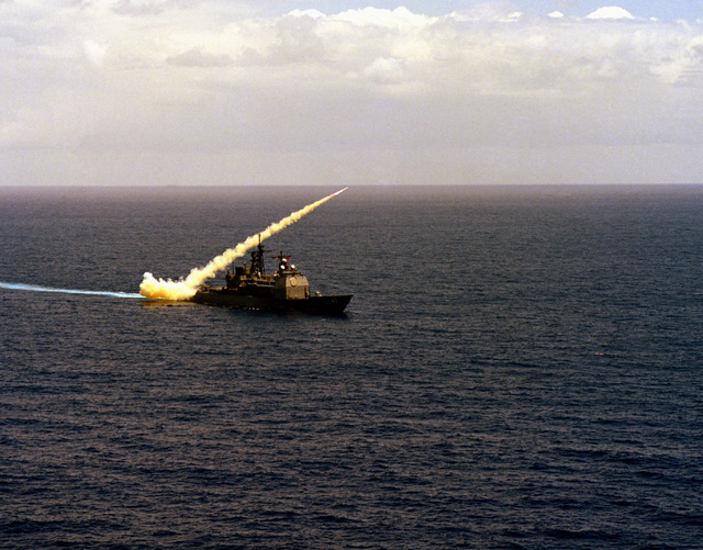 A Harpoon missile is launched from the Aegis guided missile cruiser USS ...